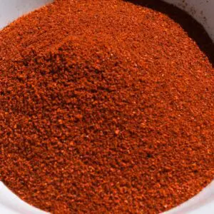 A close-up of a bowl filled with a large mound of HATCH SUN DRIED RED CHILE POWDER, CHOICE OF FLAVORS.