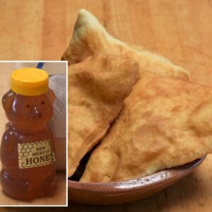 A bowl containing pieces of sopaipilla/fry bread mix is placed next to a bear-shaped bottle labeled "New Mexico Wildflower Honey.