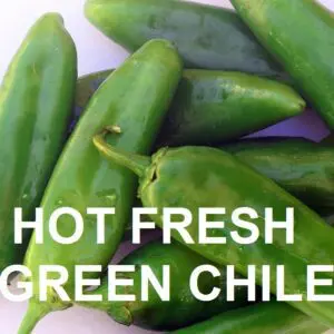 Close-up of several fresh green chiles with the text "HOT SANDIA GREEN CHILE - FRESH" overlaying the image.