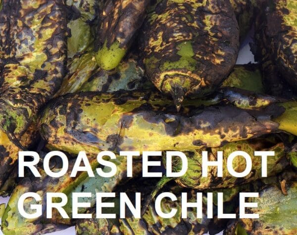 Close-up of several roasted Sandia green chile peppers with charred skins. Text overlay reads "ROASTED HOT SANDIA GREEN CHILE.