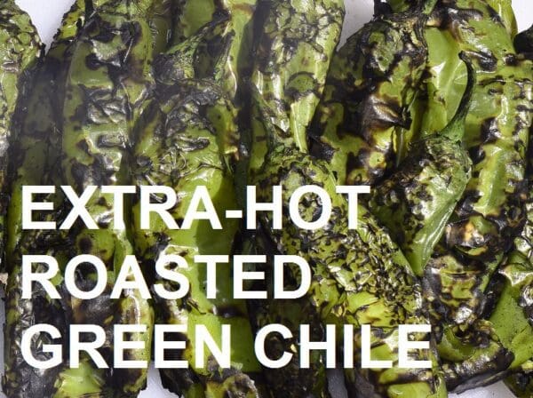 Close-up of several roasted green chiles with a charred appearance, overlaid with the text "EXTRA-HOT BARKER'S GREEN CHILE - ROASTED.